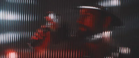 Shape of a man with camera thorugh shaped clear panel in red lights Stock Footage 203571122