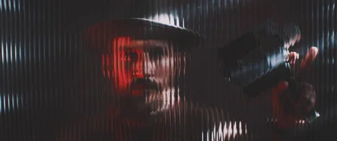 Shape of a man with camera thorugh shaped clear panel in red lights Stock Footage 203571250