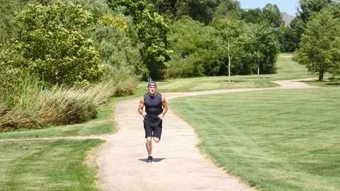 In shape man running outside in park, 4k, 60fps. Stock Footage 115272907