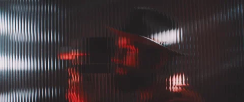 Shape of a man thorugh shaped clear panel in red lights Stock Footage 203570754