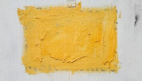 Shape painted with yellow paint on a white wall Stock Photos