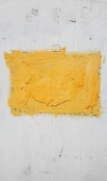 Shape painted with yellow paint on a white wall Stock Photos