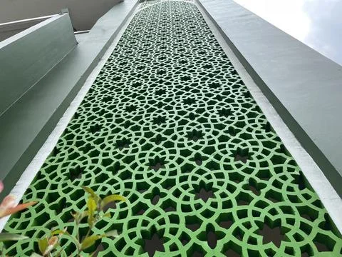 The shape of the stacked flower pattern on the green wall as a background Stock Photos