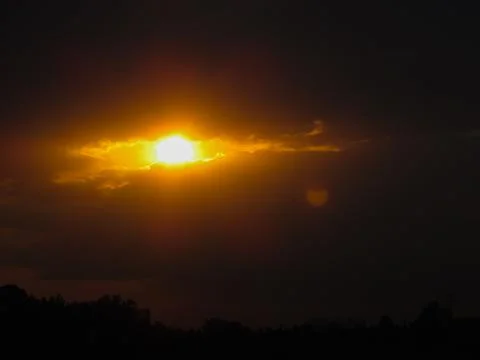 The shape of the sun and clouds looks like a burning eye in the sky Stock Photos