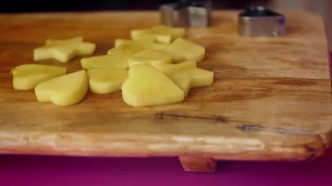 Shaped apple slices are prepared to be placed in the carved watermelon basket Stock Footage 331634498