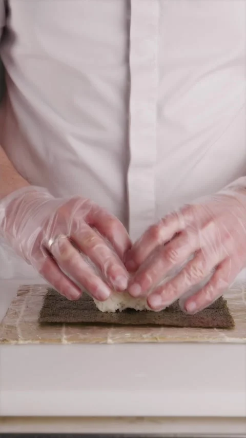 Shaper molding cooked white rice base into a sushi block Stock Footage 337119199