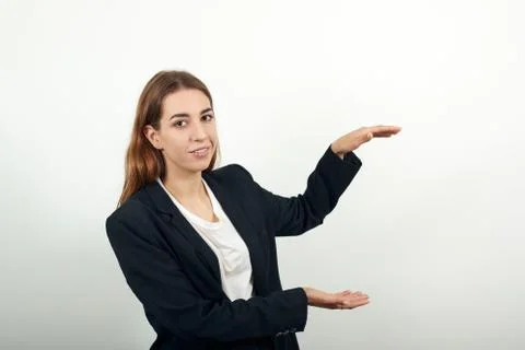 Shapes big object with two hands, gasps from surprise, holding palms in front Stock Photos