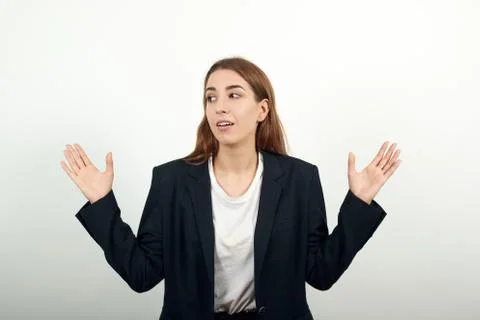 Shapes big object with two hands, gasps from surprise, holding palms in front Stock Photos