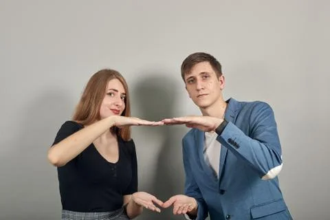 Shapes big object with two hands, gasps from surprise, holding palms in front Stock Photos