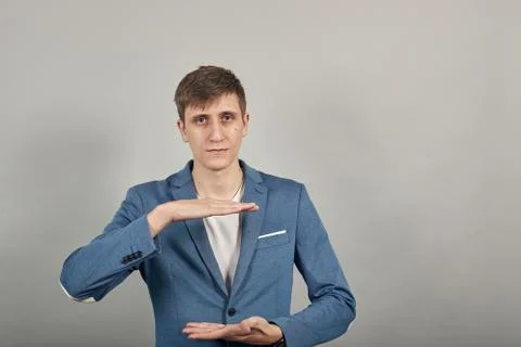 Shapes big object with two hands, gasps from surprise, holding palms in front Stock Photos