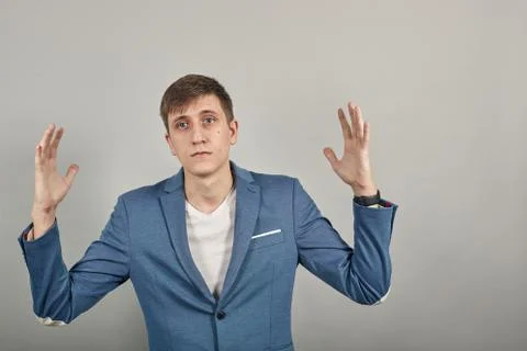 Shapes big object with two hands, gasps from surprise, holding palms in front Stock Photos