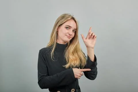 Shapes big object with two hands, gasps from surprise, holding palms in front Stock Photos