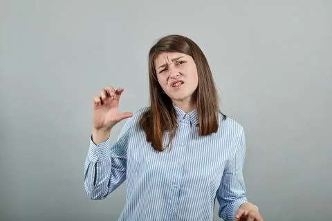 Shapes big object with two hands, gasps from surprise, holding palms in front Stock Photos