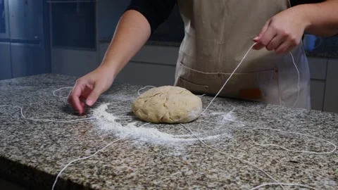 Shaping Dough on Countertop with Strings for Bread Formation Video stock 296266824