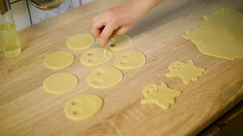 Shaping funny faces on round raw cookie dough blanks with tools Stock Footage 342704141