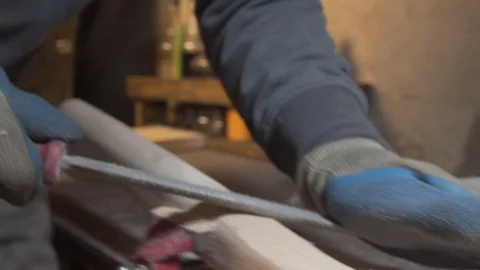 Shaping the handle of an axe Stock Footage 129695335