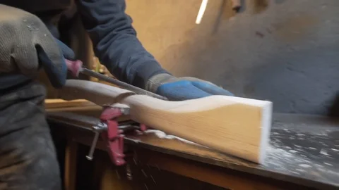 Shaping the handle of an axe Stock Footage 129814662