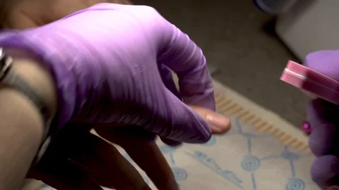 Shaping the nails by using nail file close-up in a beauty salon. Manicure proces Video stock 102536931