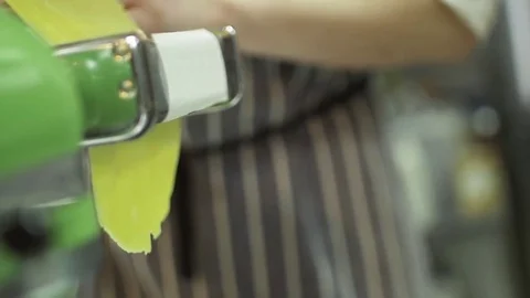 Shaping pasta dough by using a pasta machine. Close up. Dough cooked in a pasta Stock Footage 74718255