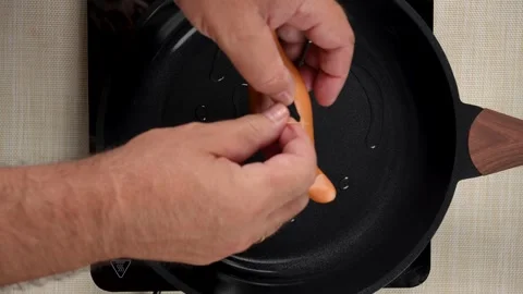 Shaping a Split Sausage with a Toothpick in a Frying Pan Video stock 342959185