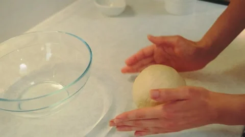 Shaping yeast dough into a ball shape Stock Footage 252371721