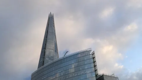 The Shard skyscraper against cloudy dramatic sky, establisher background. Stock Footage 332263855