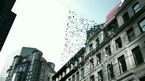 Shards of disks on strings hanging off building Stock Footage 83482452