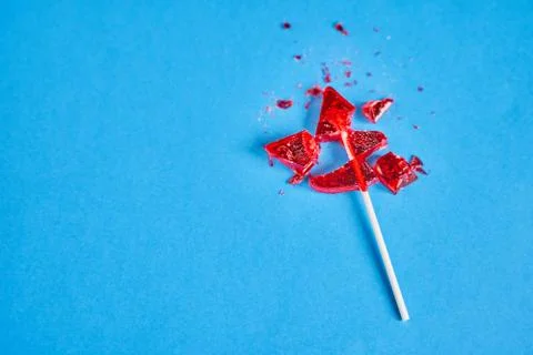 Shards of red candy on a blue background Stock Photos