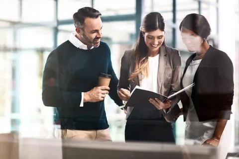 Share the task, share the success. a group of businesspeople discussing Stock Photos