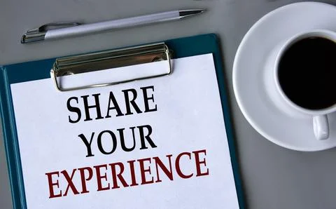 SHARE YOUR EXPERIENCE - words on a white sheet on a gray background with a .. Stock Photos