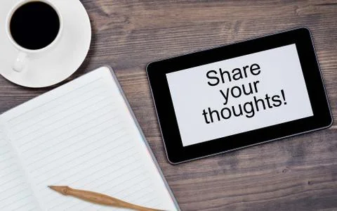 Share your thoughts! Text on tablet device on a wooden table Stock Photos