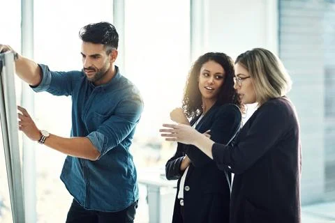 Shared ideas bring success. a group of colleagues having a brainstorming session Stock Photos