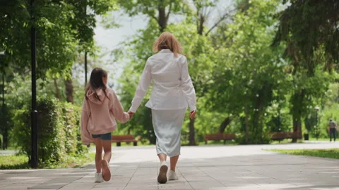 Shared peaceful park outing. Serene walk with family in sunshine. Calm 스톡 동영상 331955854
