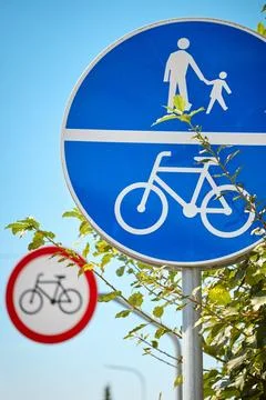 Shared pedestrian and bicycle path sign with no bicycles sign in the backgrou Stock Photos