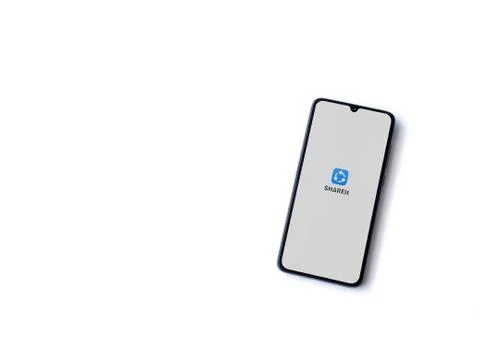 SHAREit app launch screen with logo on the display of a black mobile smartpho Stock Photos