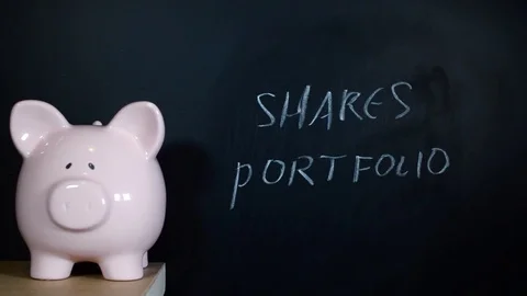Shares portfolio handwriten on a chalk board by a financial planner Stock Footage 81931253