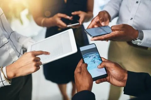 Sharing data via the cloud. Closeup shot of a group of businesspeople using Stock Photos