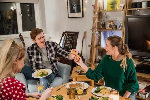 Sharing Garlic Bread at a Dinner Party Fotos Stock