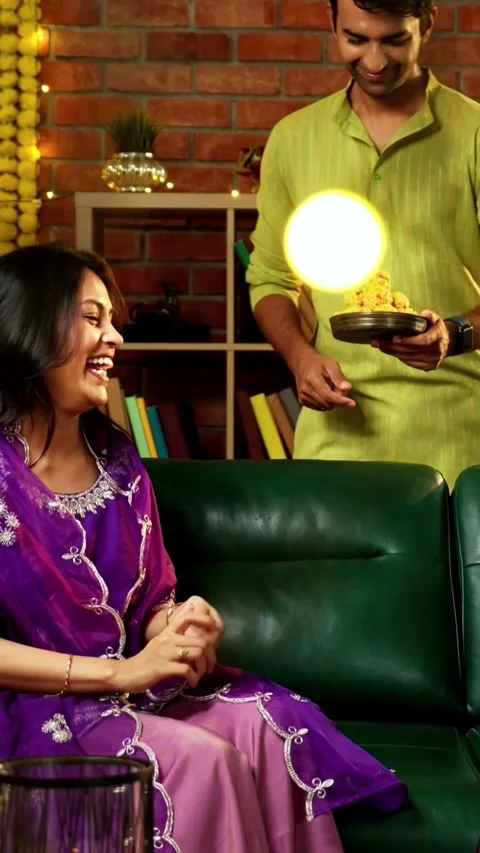 Sharing laddoo while celebrating Diwali with friends and family in festival Video stock 342384876