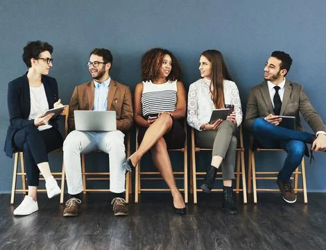 Sharing a laugh before the interview. Studio shot of a group of businesspeople Stock Photos