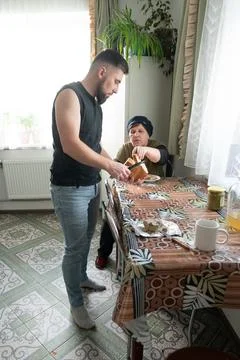 Sharing a moment at the kitchen table during a cozy afternoon at home, wher.. Fotos de archivo