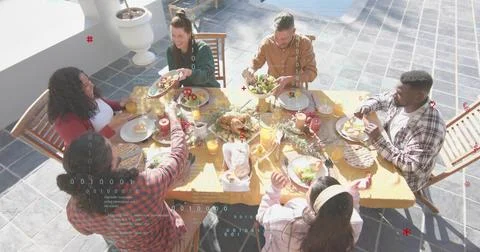 Sharing six adults wearing patterned shirt, passing plates on sunlit terrace, 스톡 사진