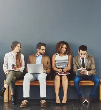 Sharing some pre-interview tips. Studio shot of a group of businesspeople using Stock Photos