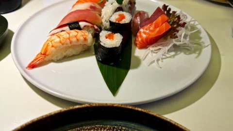 Sharing Sushi Selection With Different Rolls at a Restaurant Table Video stock 328973257