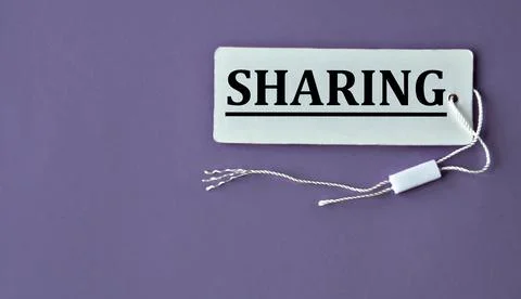 SHARING - word on white paper with thread on a purple background Stock Photos