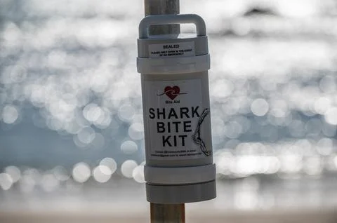 Shark bite kit on a pole against sea background Stock Photos