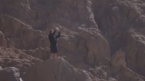 SHARM EL SHEIKH, EGYPT - MARCH 3: Man in the desert takes photo of dune Stock Footage 73974764