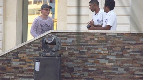 SHARM EL SHEIKH, EGYPT - MARCH 3: Hotel crew talking with resting man Stock Footage 73976191