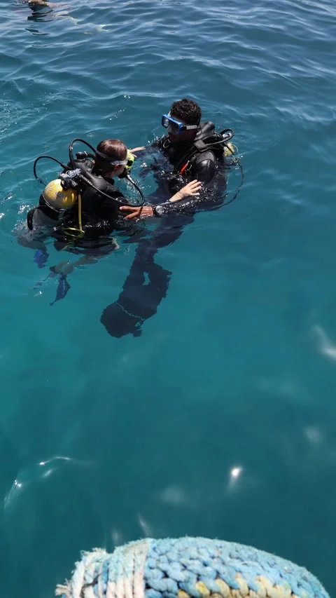 Sharm El Sheikh Egypt — May 6 2025 — Vertical screen — Scuba instructor supports Stock Footage 311845662