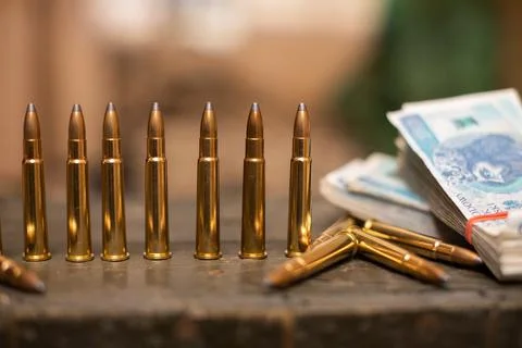 Sharp ammunition and a bundle of banknotes lie in a military box. 写真素材